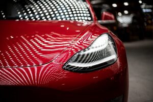 Close-up of red Tesla in garage