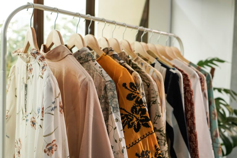 Colourful blouses hanging on clothes rack