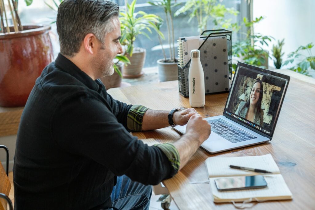 Man speaks with woman in virtual meeting