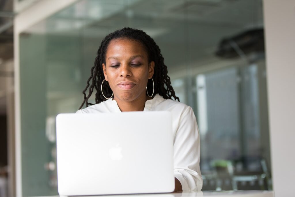 Woman works on Apple Mac laptop