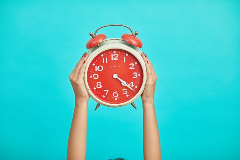 Woman's hands hold up clock