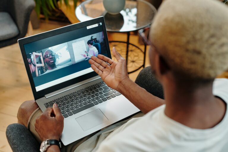 photo of a person speaking with someone else in a video chat on a laptop