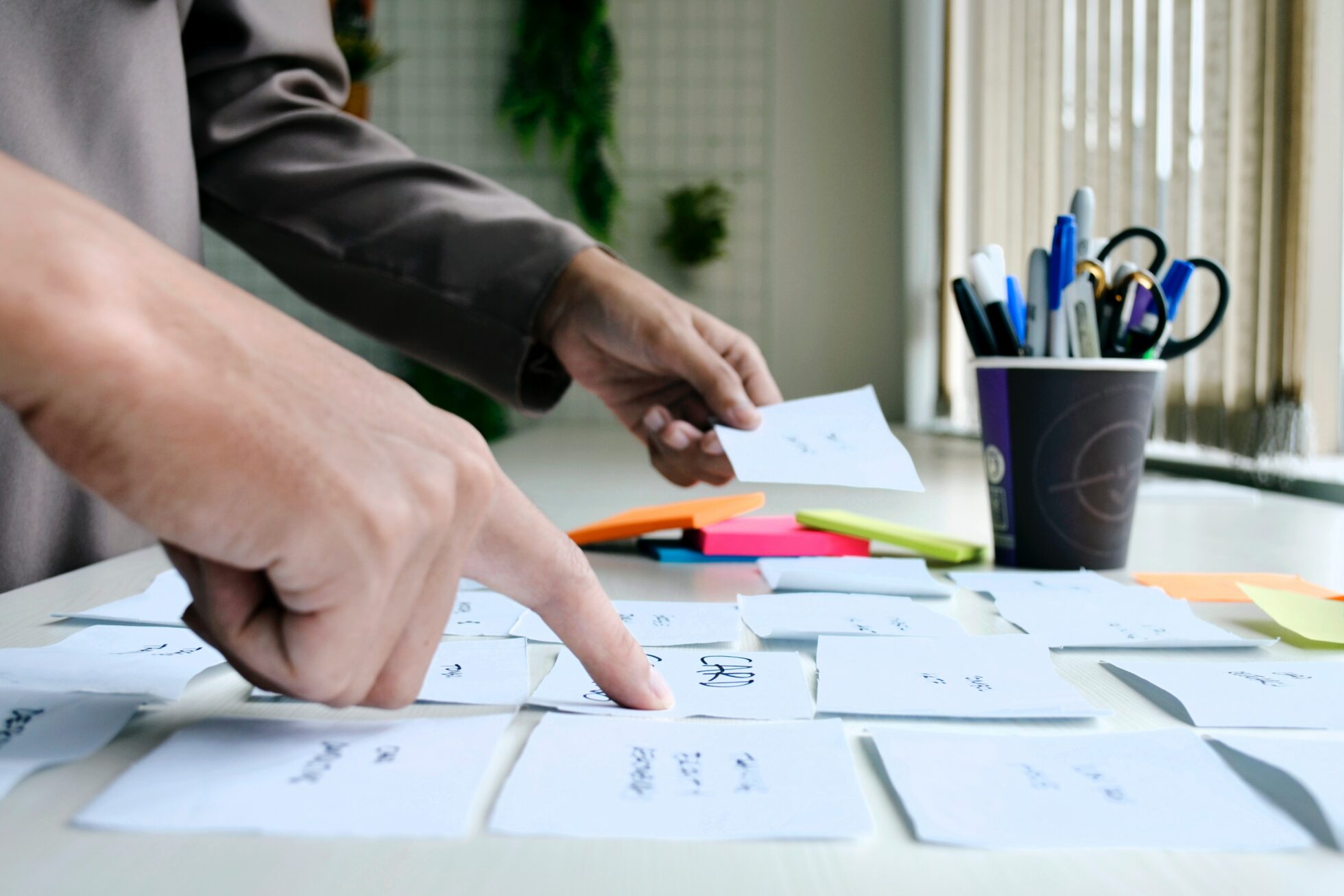 image of hands at a desk doing card sorting