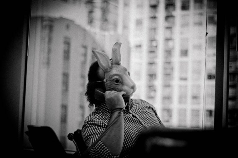 man on the phone wearing a rabbit mask