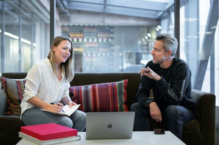 image of two people on a laptop to illustrate the sales playbook